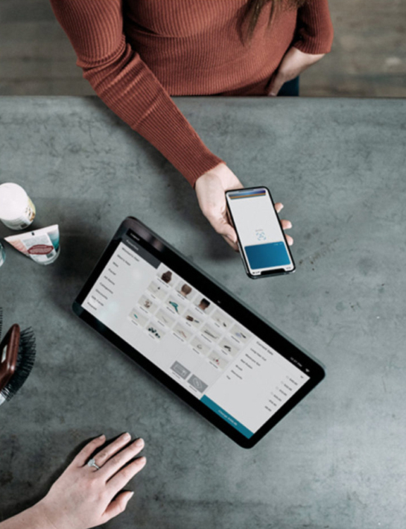 Two people working with devices shot from overhead.